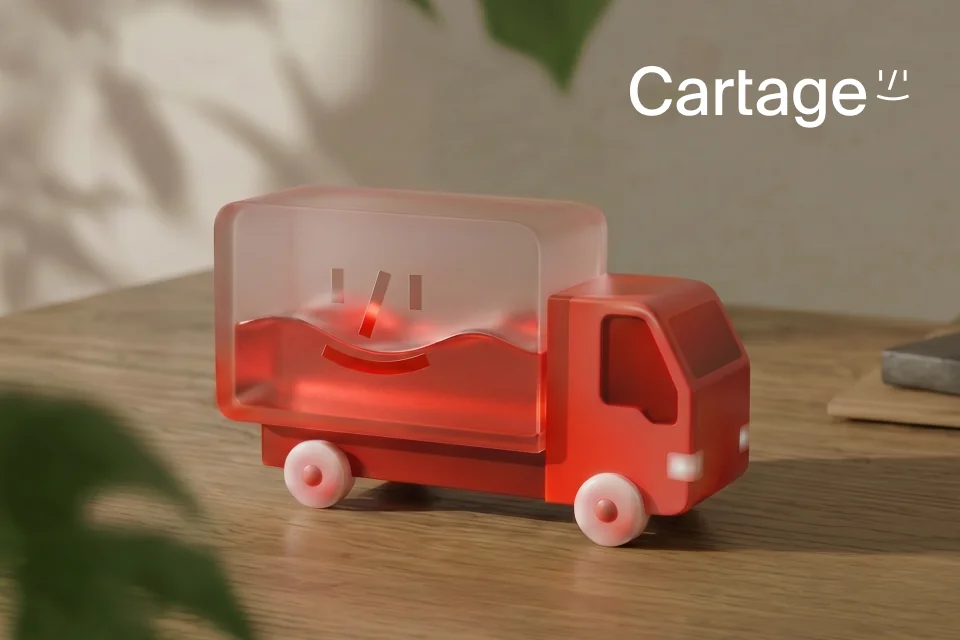 A glossy red Cartage truck icon on a wooden table