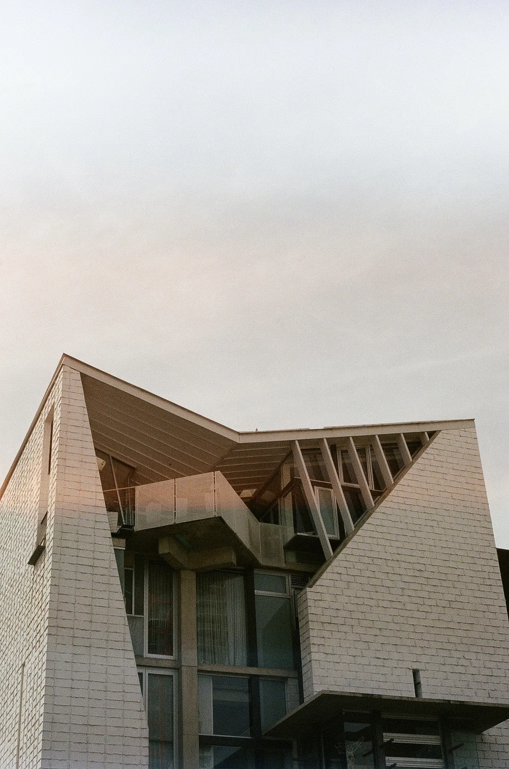 An angular tiled building against a pale sky