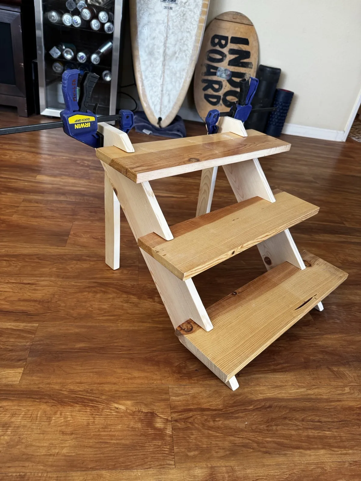 A stepped wooden plant stand with white sides